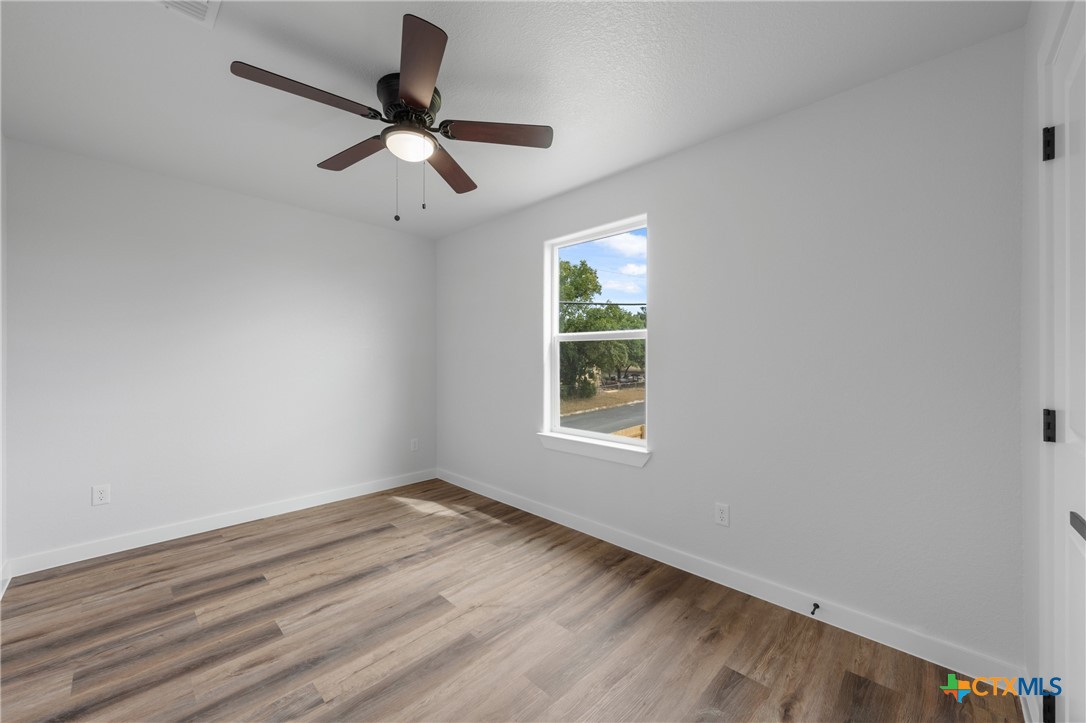 712 South 28th Street, Unit A Temple, TX 76501 - Photo 21 of 24 an empty room with ceiling fan and window