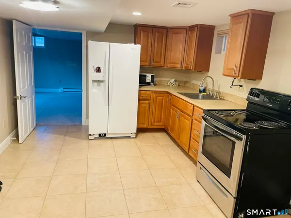 a kitchen with stainless steel appliances granite countertop a refrigerator stove and sink