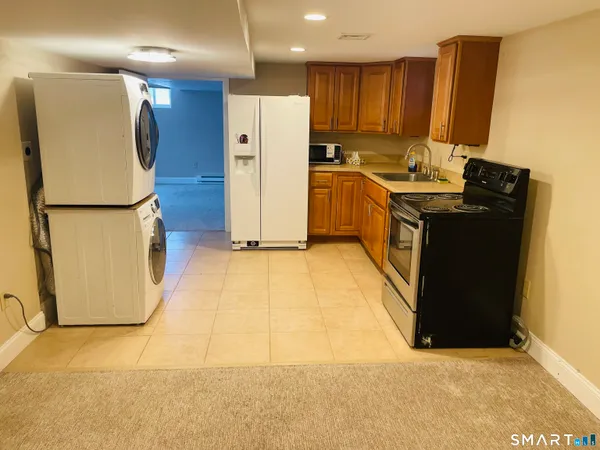 a kitchen with a refrigerator and a stove