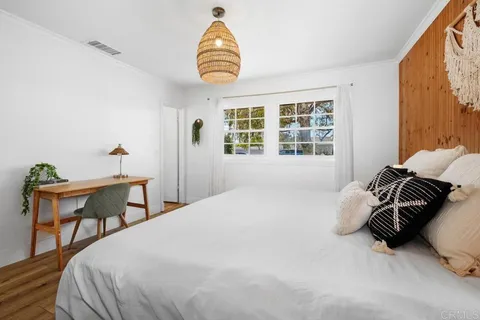 a bedroom with a bed and a chair