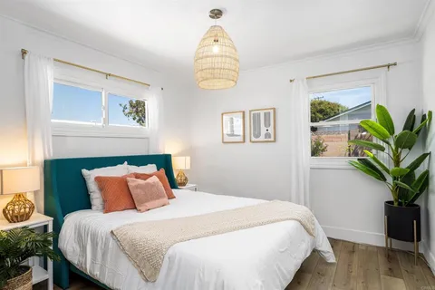 a bedroom with bed and a window