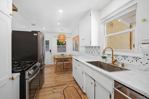 a kitchen with stainless steel appliances a stove sink and microwave