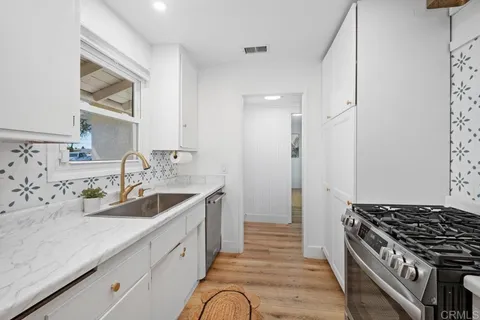a spacious bathroom with a double vanity sink and a mirror