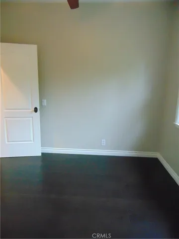 a view of an empty room and wooden floor