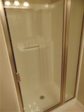 a bathroom with a glass shower door