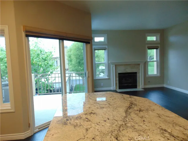 a view of empty room with wooden floor and fireplace