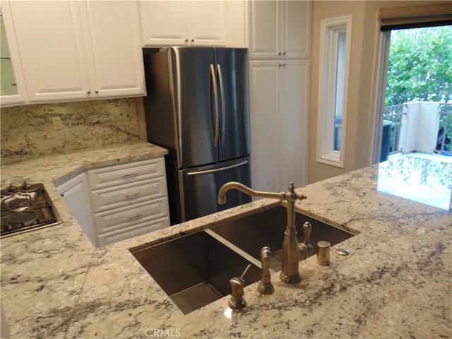 a kitchen with a refrigerator and a sink