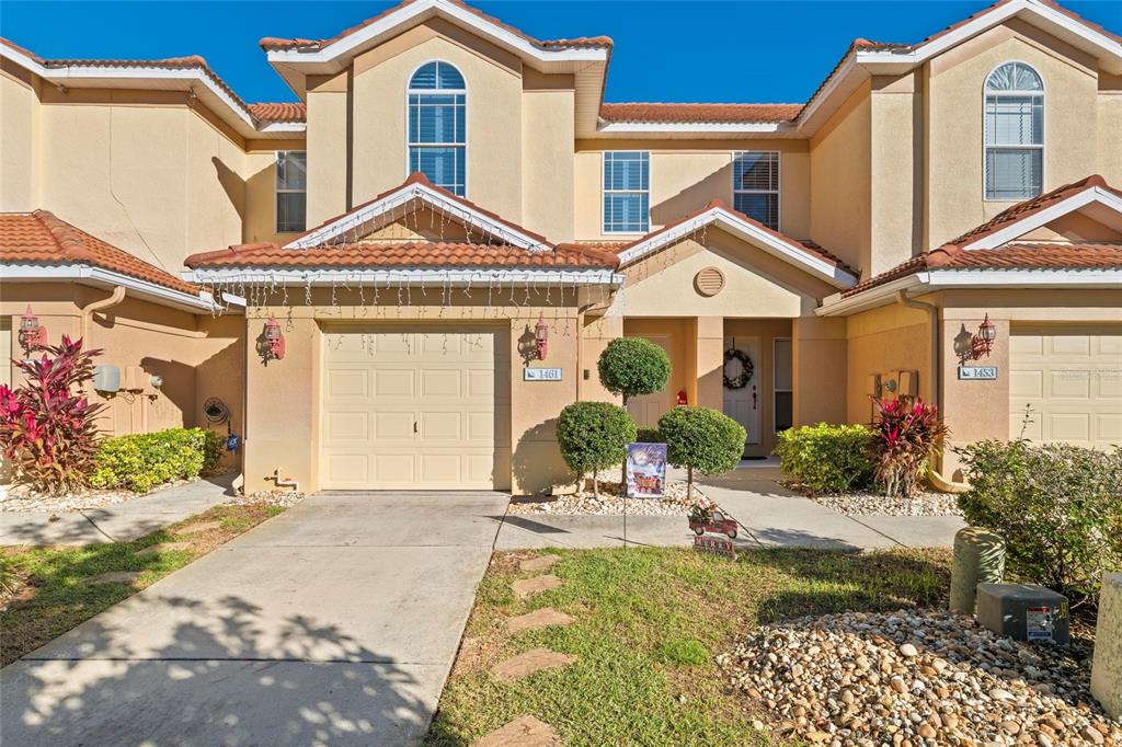 1461 Ridge Terrace Tarpon Springs, FL 34689 - Photo 2 of 25 a front view of a house with a yard and garage