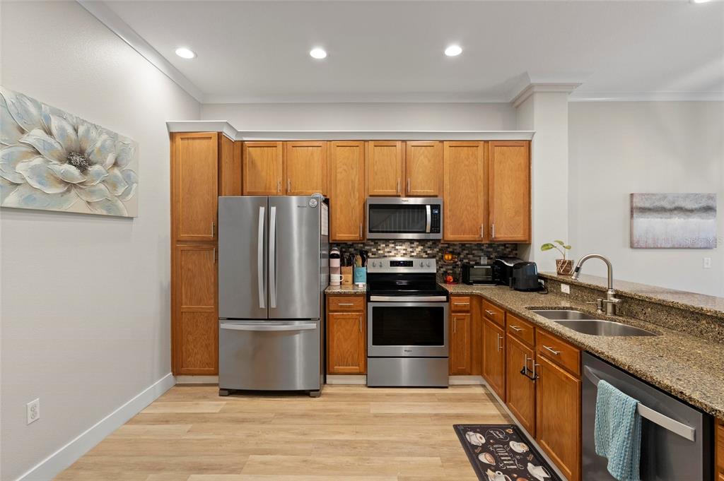 1461 Ridge Terrace Tarpon Springs, FL 34689 - Photo 7 of 25 a kitchen with stainless steel appliances granite countertop a refrigerator stove and sink