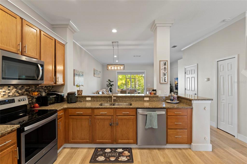 1461 Ridge Terrace Tarpon Springs, FL 34689 - Photo 8 of 25 a kitchen with a sink stove and microwave
