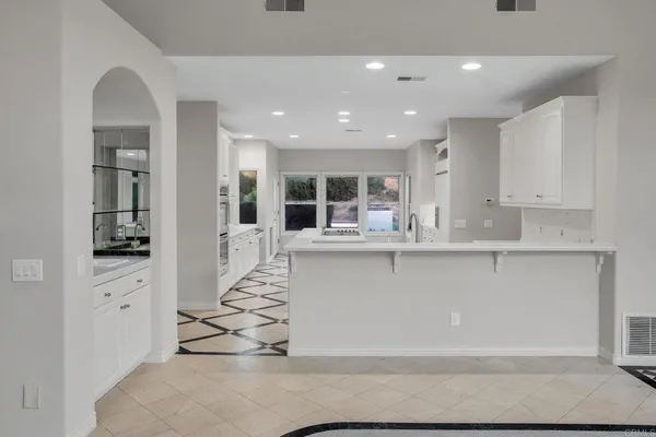 a kitchen with sink refrigerator and cabinets