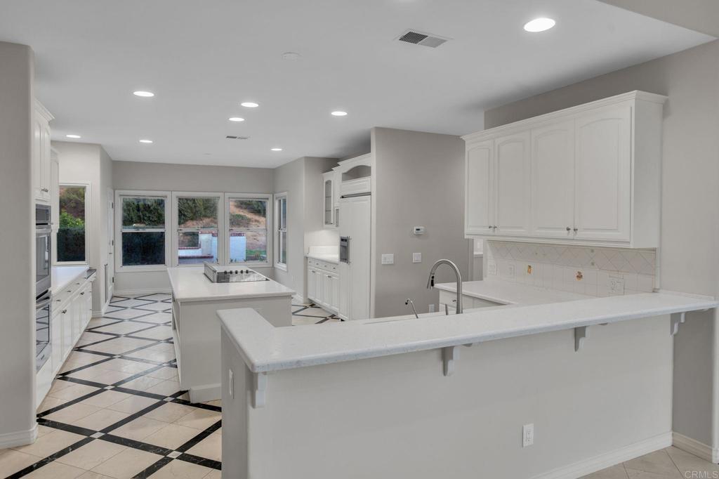 4286 La Canada Road Fallbrook, CA 92028 - Photo 18 of 60 a kitchen with sink refrigerator and cabinets