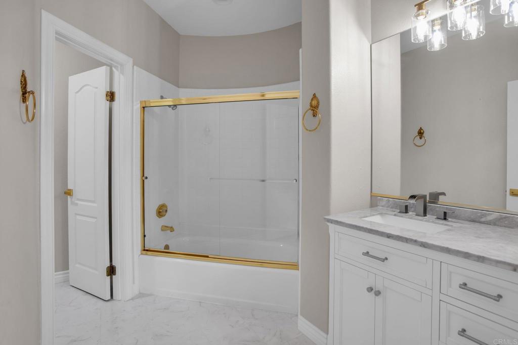 4286 La Canada Road Fallbrook, CA 92028 - Photo 30 of 60 a bathroom with a granite countertop sink a mirror and a shower