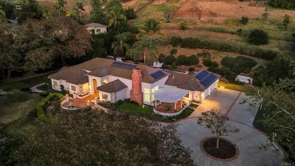 an aerial view of a house with garden space and street view