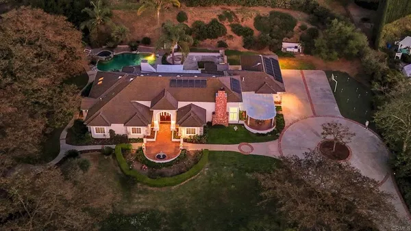 a front view of a house with yard and green space