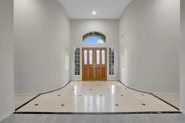 a view of an empty room with a fireplace and a window