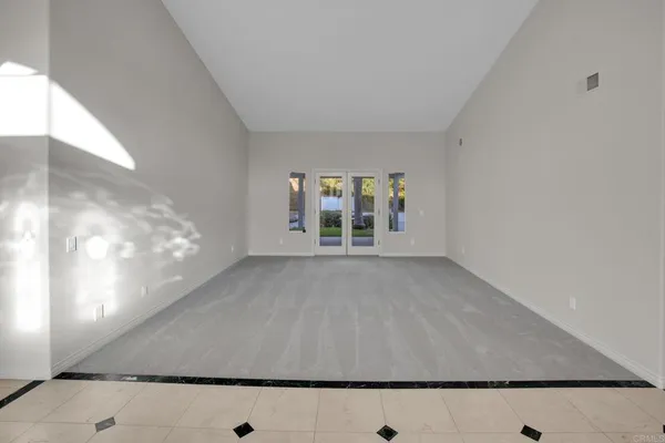 a view of an empty room with a fireplace and a window