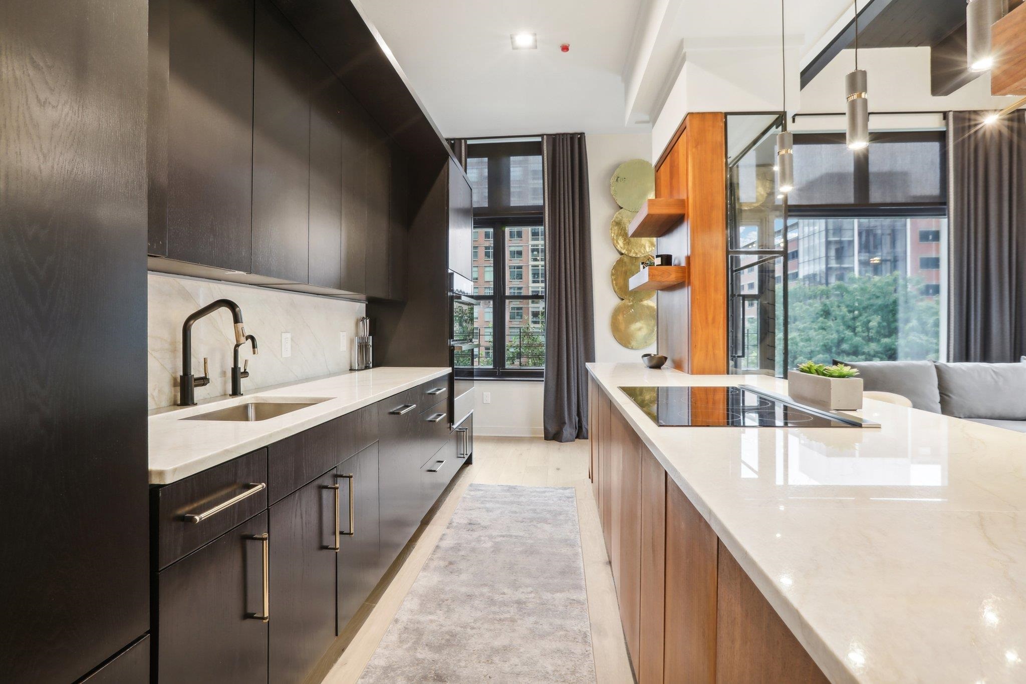 1500 Washington Street, Unit 3D Hoboken, NJ 07030 - Photo 9 of 23 a large kitchen with kitchen island a large window a sink and stainless steel appliances
