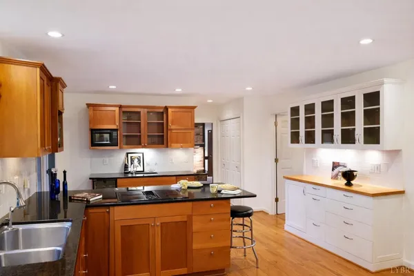 a kitchen with stainless steel appliances granite countertop a sink stove and cabinets