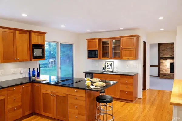 a kitchen with stainless steel appliances granite countertop a sink and cabinets