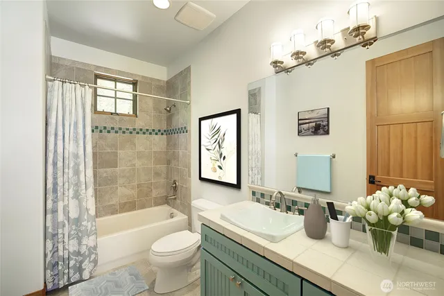 a bathroom with a double vanity sink toilet and shower