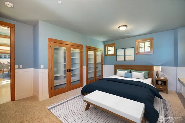 a bedroom with a large bed and a large window