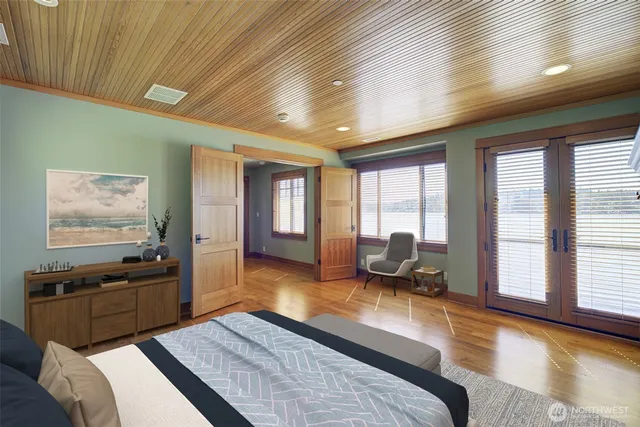 a bedroom with furniture and large windows