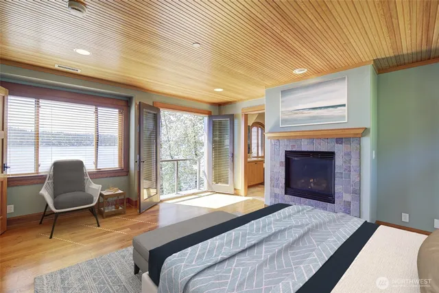 a spacious bedroom with a large bed and a fireplace