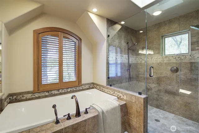 a bathroom with a bathtub and shower