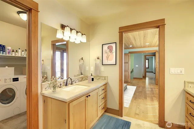 a spacious bathroom with a sink mirror and vanity