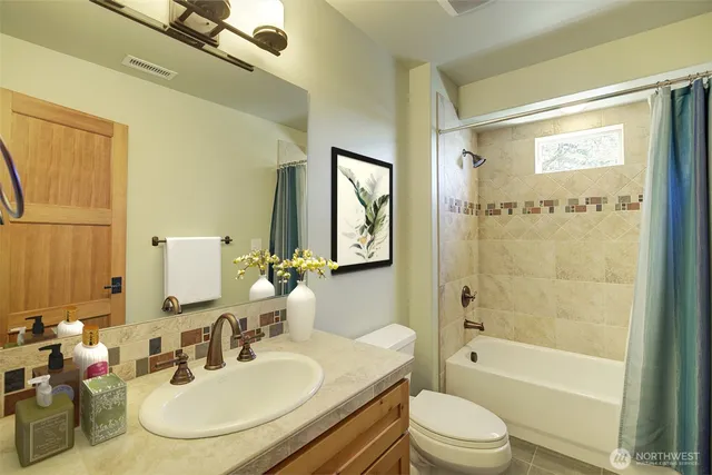 a bathroom with a sink toilet tub and shower