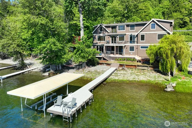 a view of a house with pool and chairs