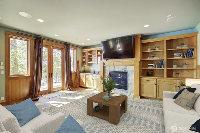a living room with furniture a fireplace and a flat screen tv