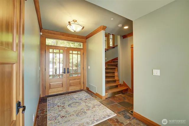a view of a hallway with wooden floor and cabinet