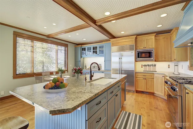 a kitchen with sink a stove and cabinets