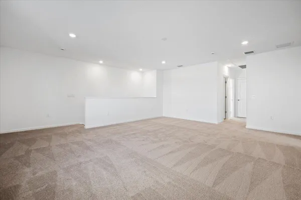 an empty room with a empty space and windows