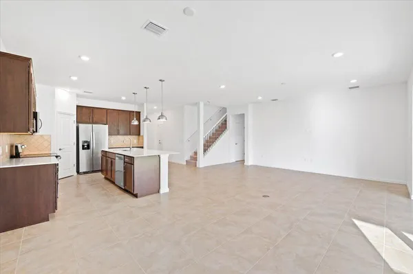 a view of kitchen with stainless steel appliances a refrigerator and a counter top space