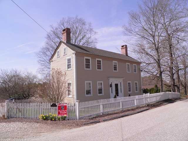 a front view of a house with a road