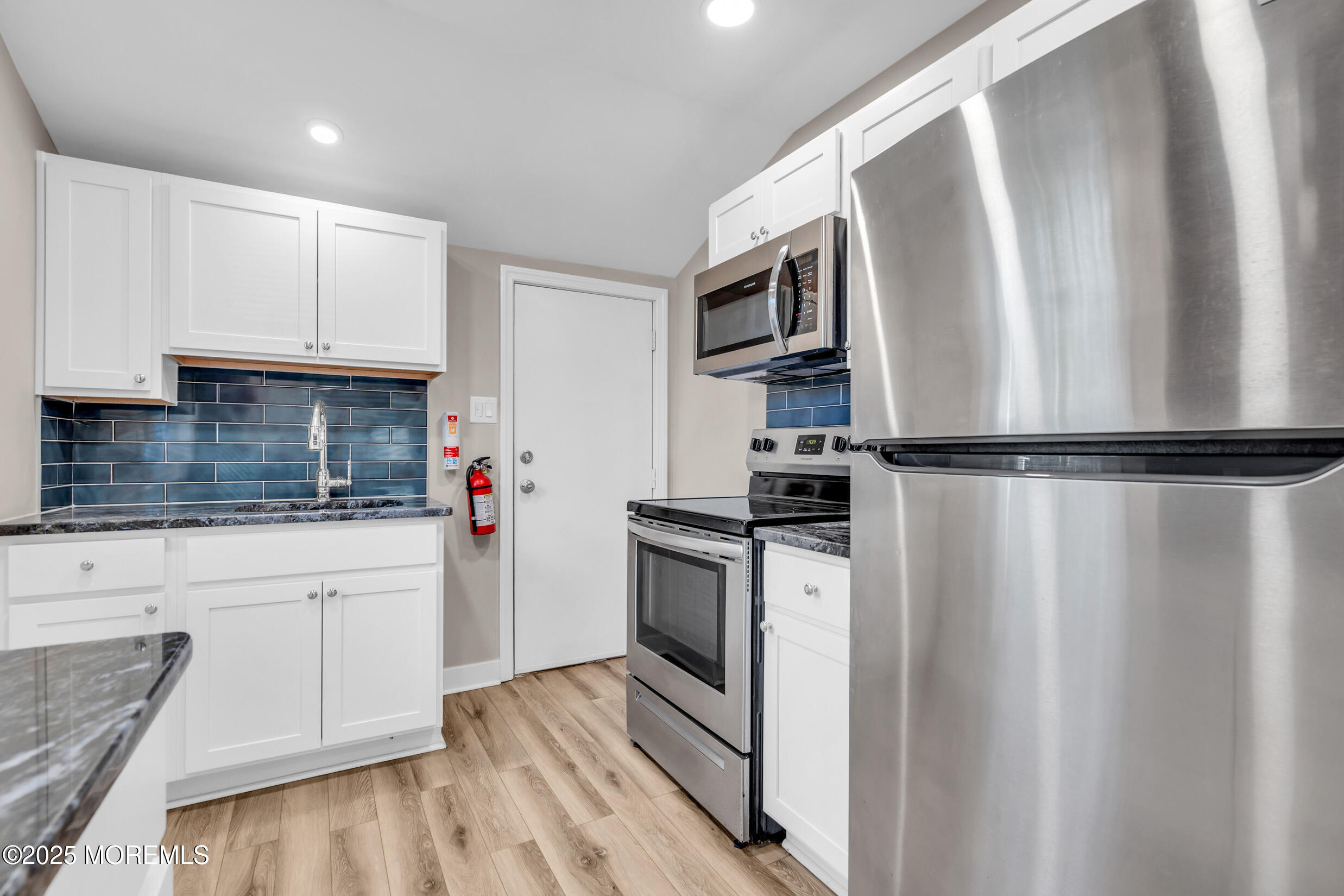 4 Pine Bluff Road Toms River, NJ 08753 - Photo 14 of 39 a kitchen with stainless steel appliances a refrigerator sink and microwave