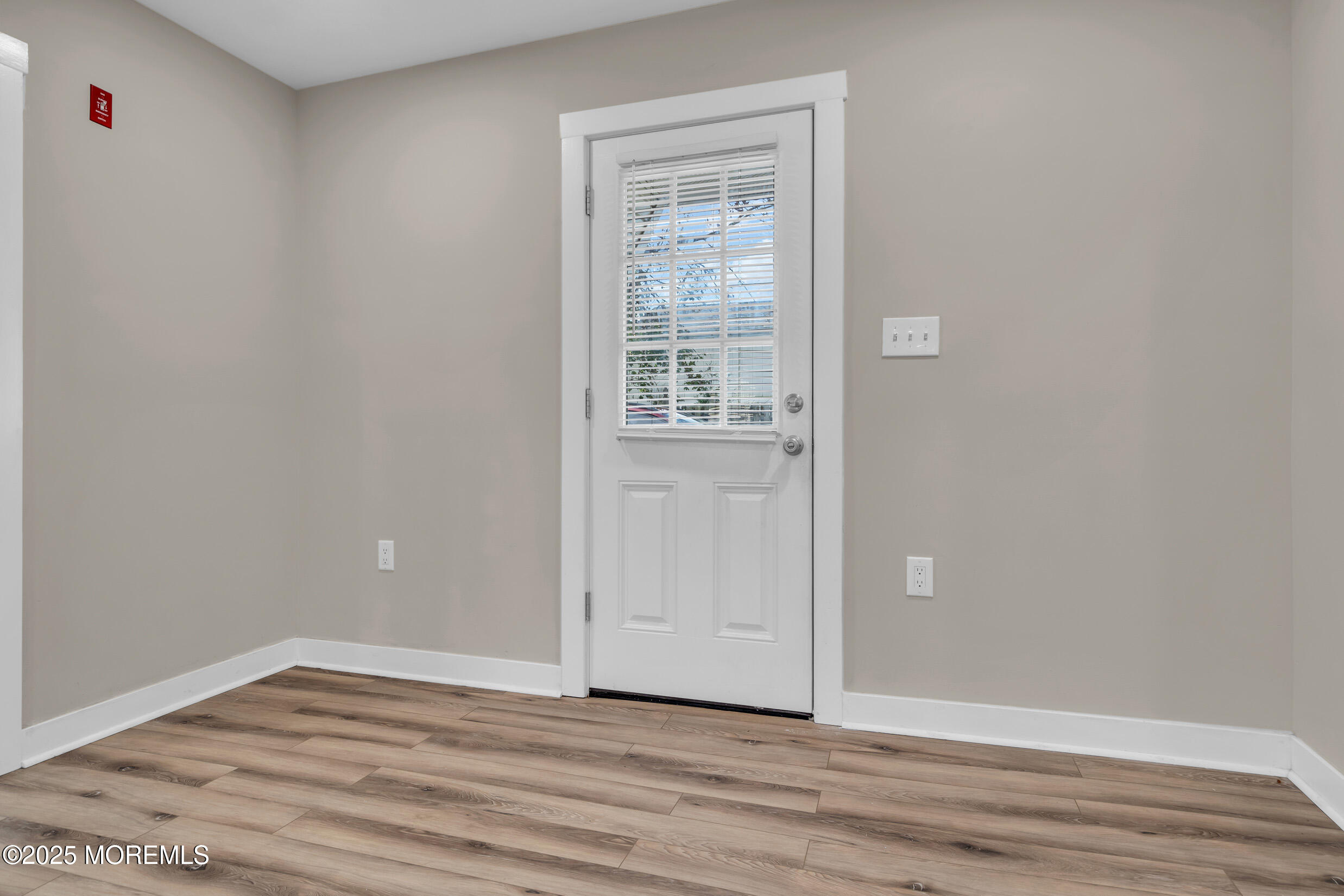 4 Pine Bluff Road Toms River, NJ 08753 - Photo 8 of 39 a view of an empty room with wooden floor and a window