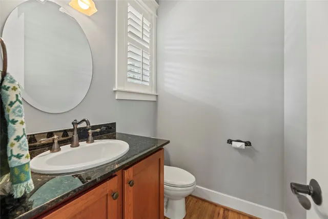 a dining room with furniture a chandelier and wooden floor