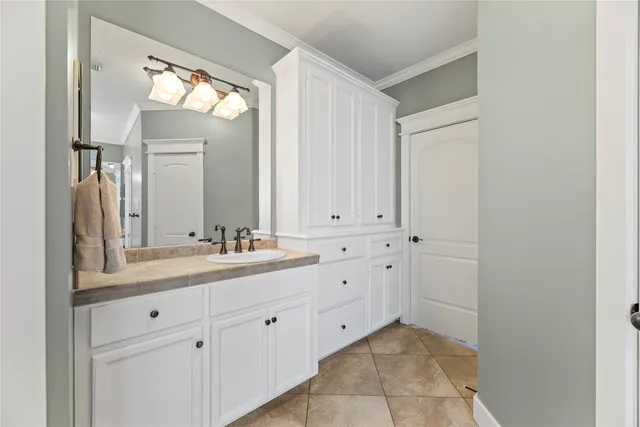 a spacious bathroom with a granite countertop sink