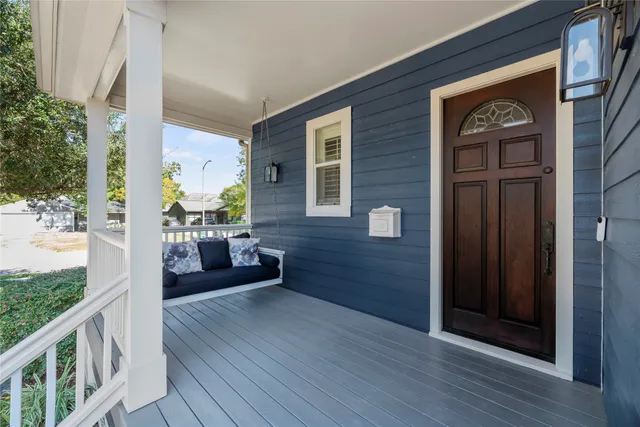 a front view of a house with a garden and trees