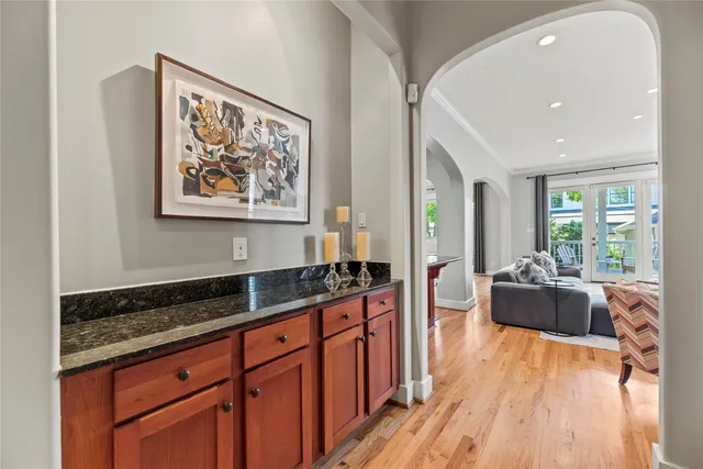 a large kitchen with stainless steel appliances a stove a sink a refrigerator and wooden floor