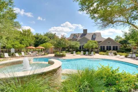 a view of a house with swimming pool and sitting area