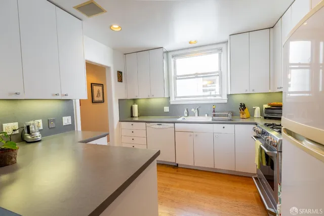 a kitchen with cabinets a sink and appliances