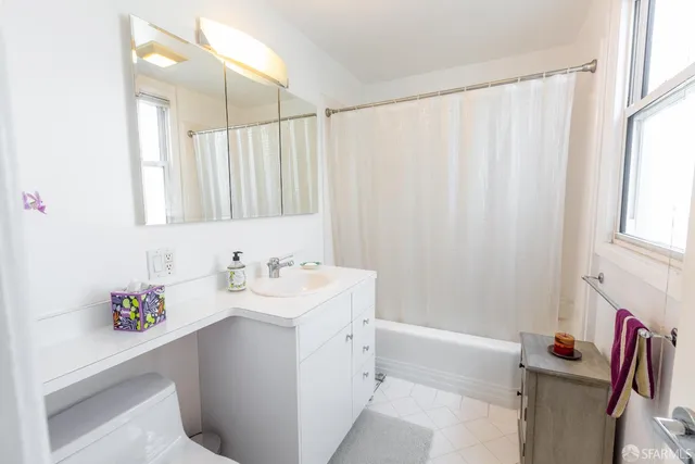 a bathroom with a sink a mirror and a shower