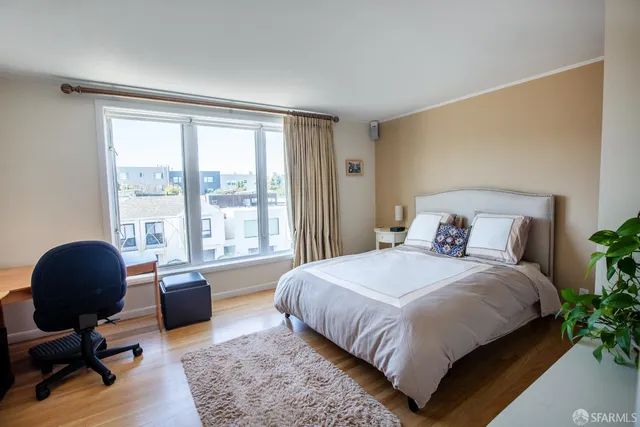 a bedroom with a large bed and a large window