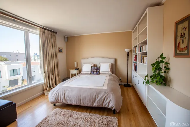 a bedroom with a large bed and a large window