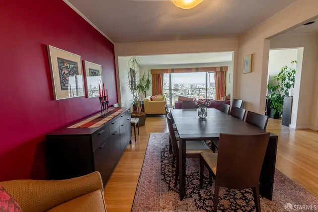 a kitchen with a table chairs and wooden floor